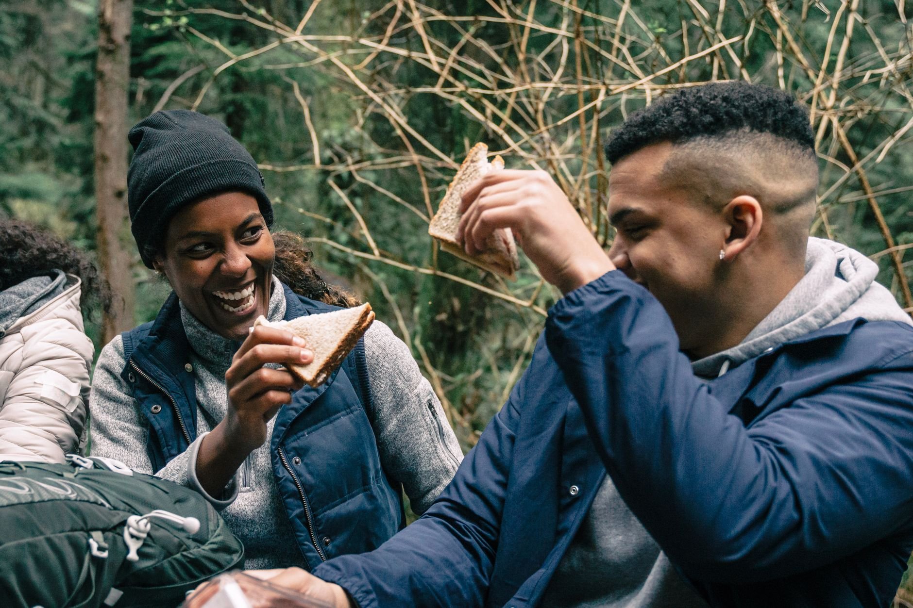 Two friends laughing and sharing during an outdoor gathering — the kind of warmth SHYRA brings to sharing.